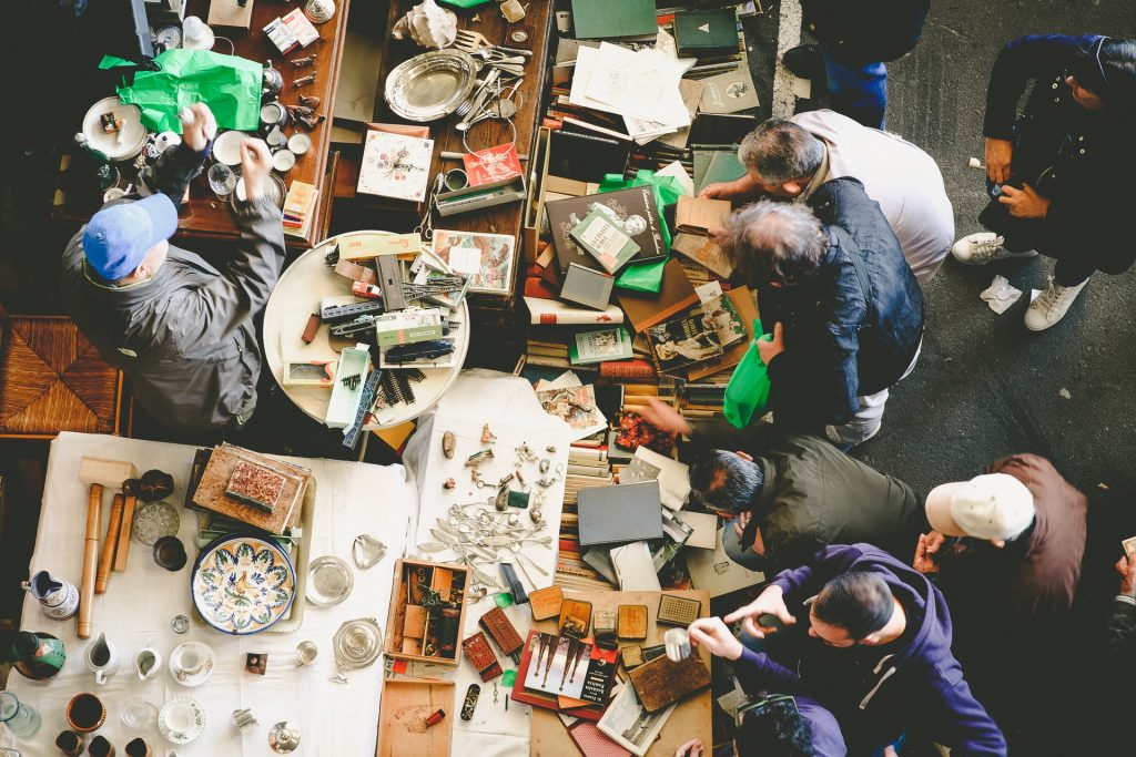 Picture of multiple people working in a workspace from above